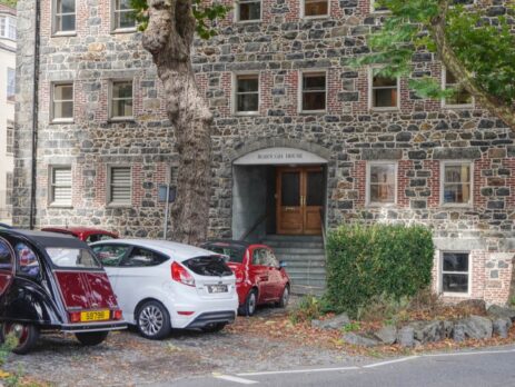 An image of Borough House in Guernsey with some cars parked outside