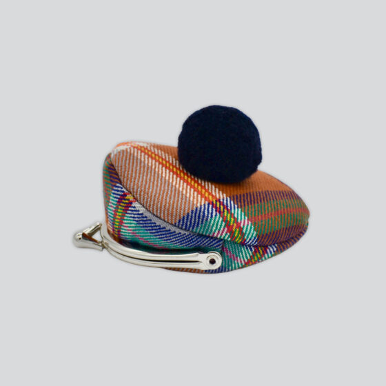 A purse in the Guernsey Tartan pattern with a bobble on top.